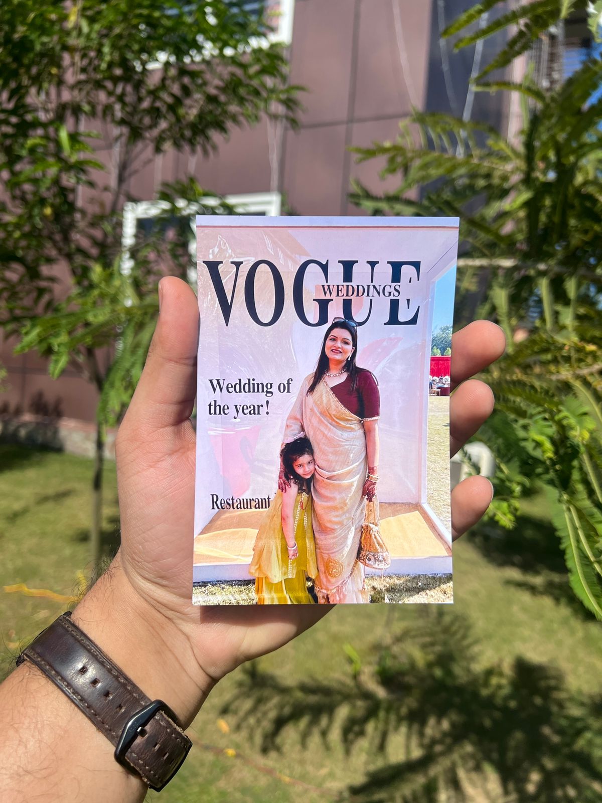 Custom Vogue-style magazine photo booth print featuring wedding guests, creating personalized magazine cover keepsakes at a wedding celebration.